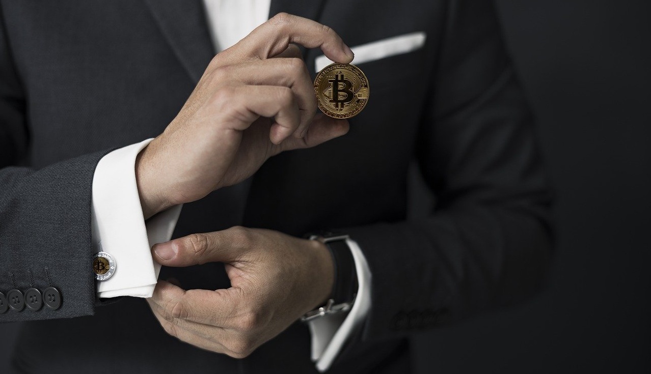 Man with a bitcoin in the hand